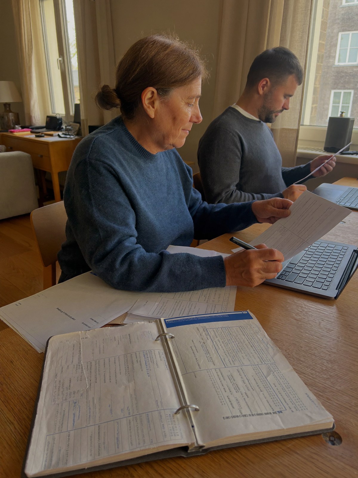 Taxpayer reviewing income records at an apartment desk