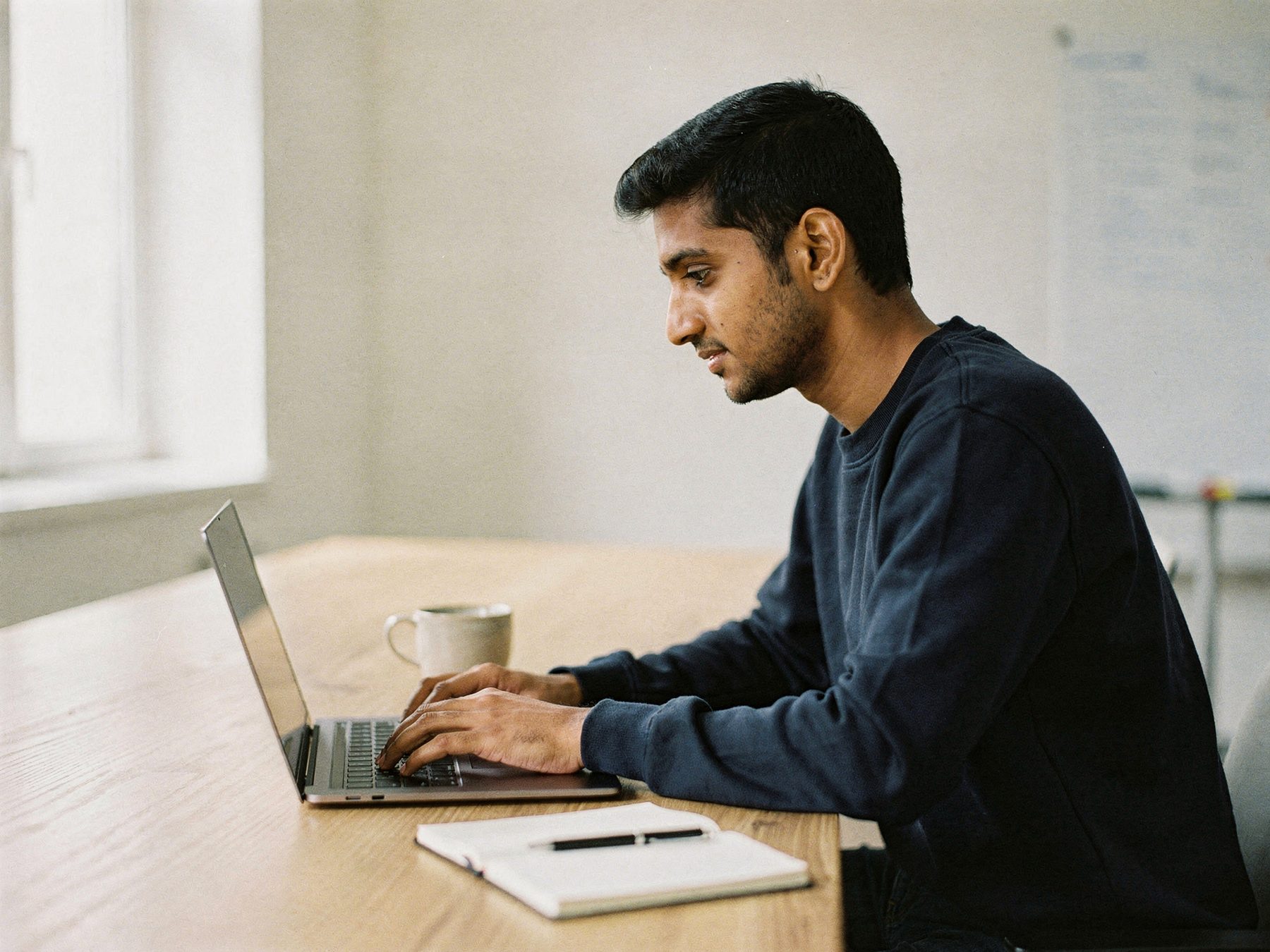 A founder working on a laptop at a desk